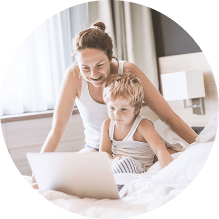 Woman and child looking at laptop in hotel room