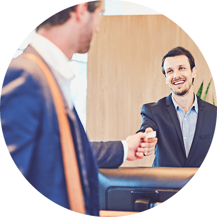 Front desk manager handing guest a keycard